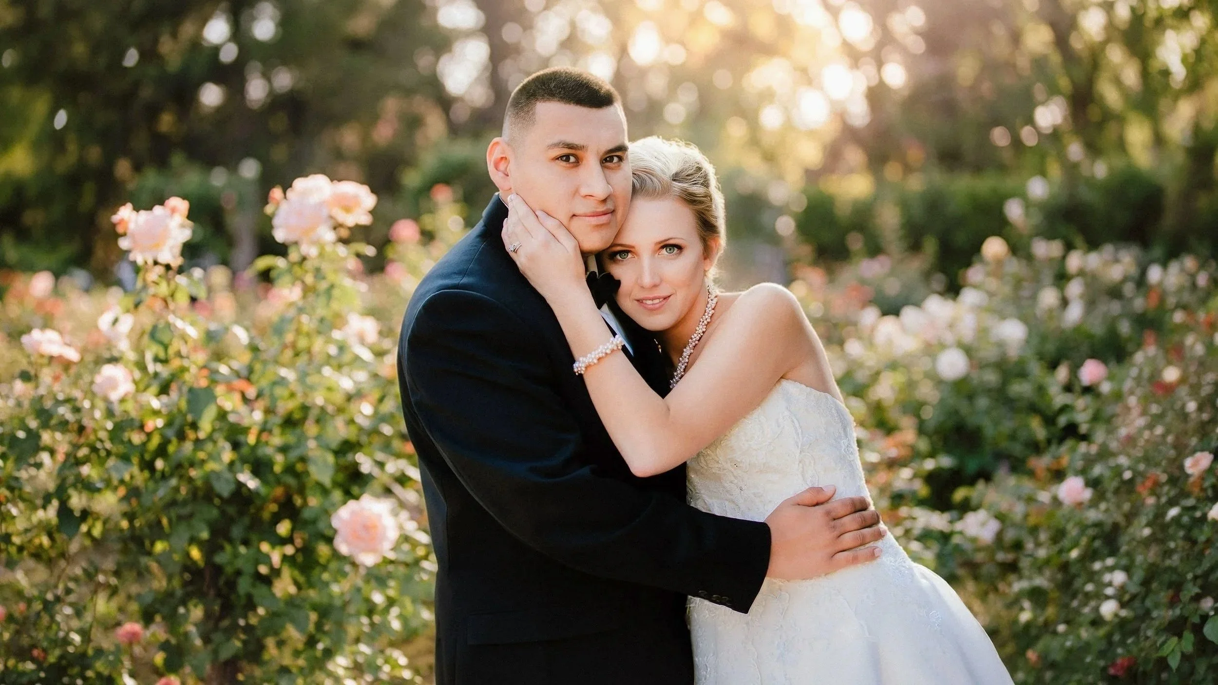 Backlit newlywed couple embracing in a garden at sunset