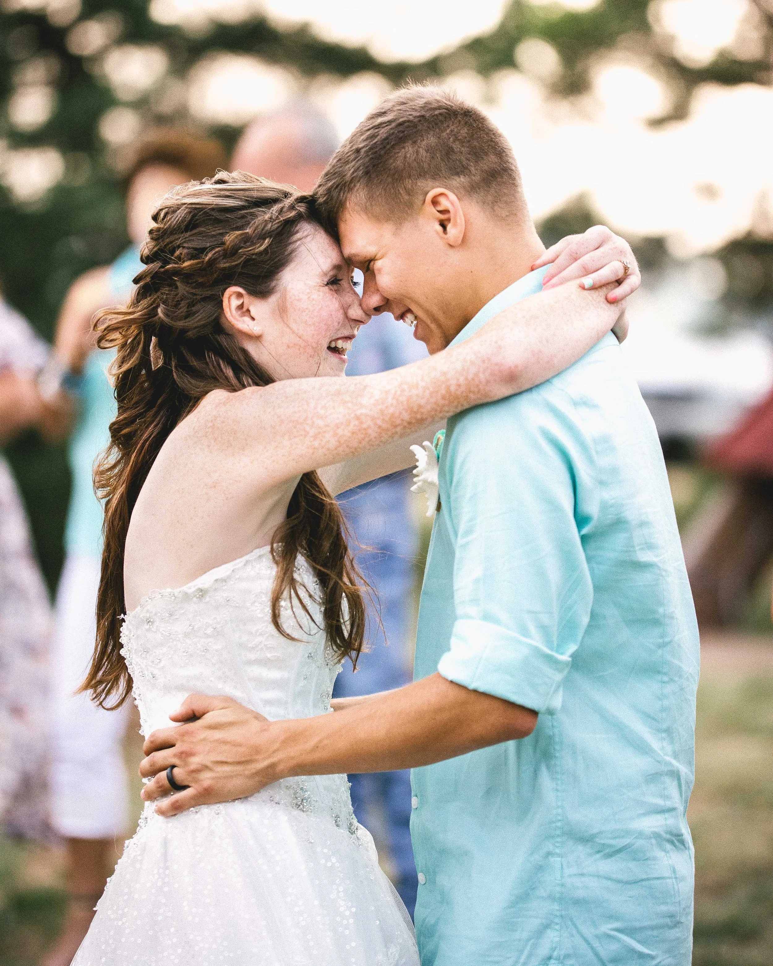 A couple dancing outdoors with foreheads touching