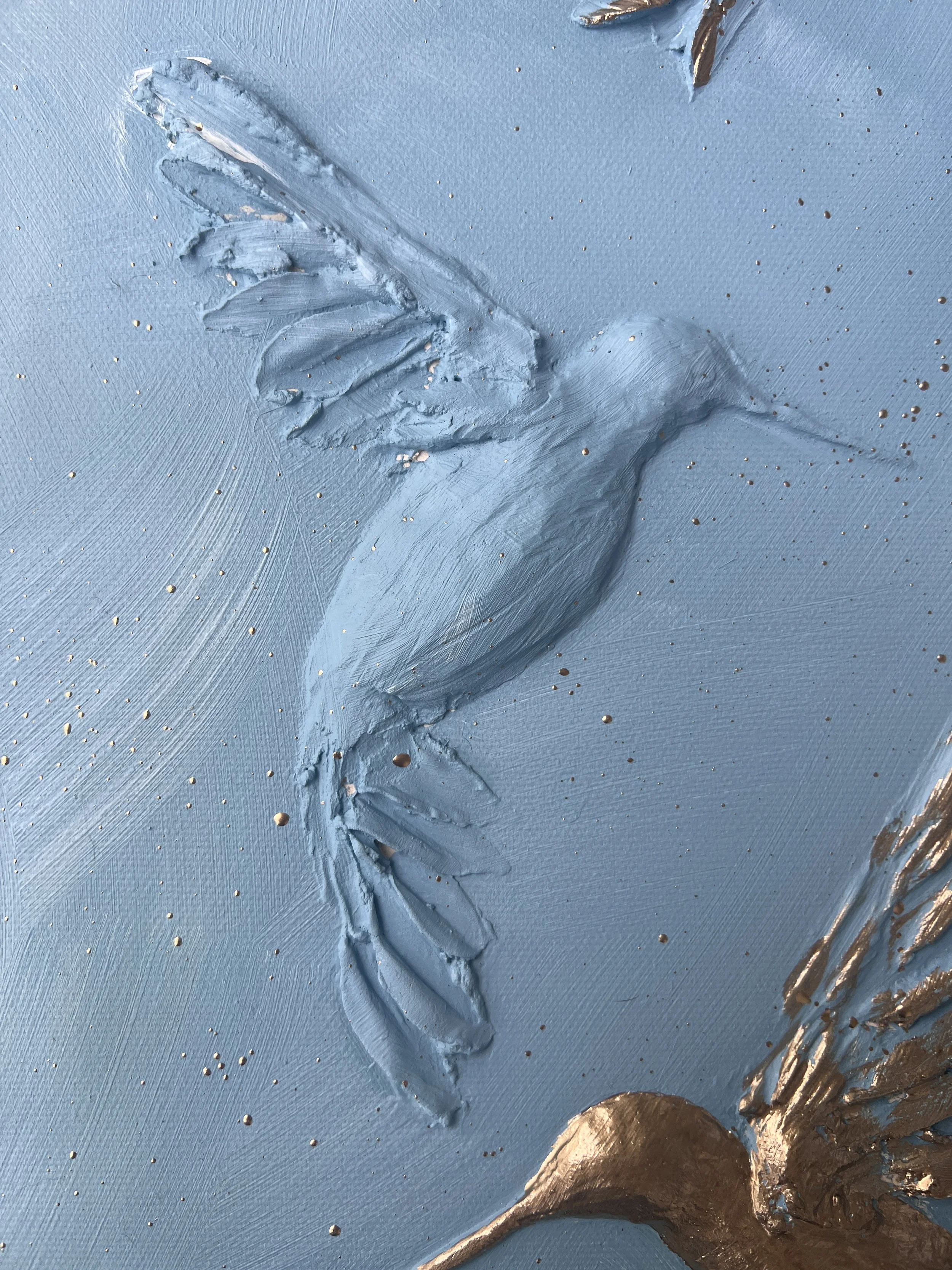 A textured painting of a hummingbird in flight on a blue background, with gold accents.