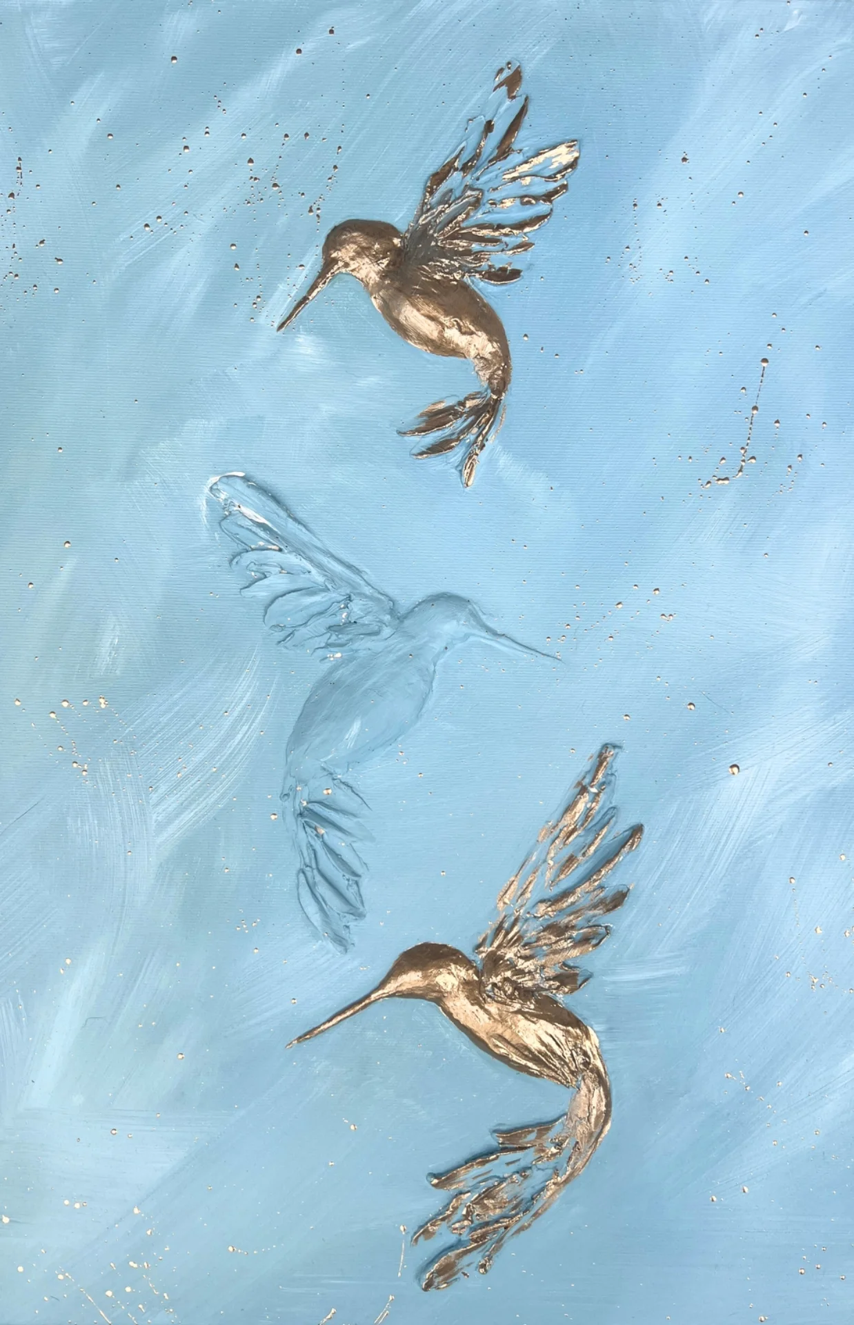 Painting of three hummingbirds flying in a blue sky background, with gold and silver accents.