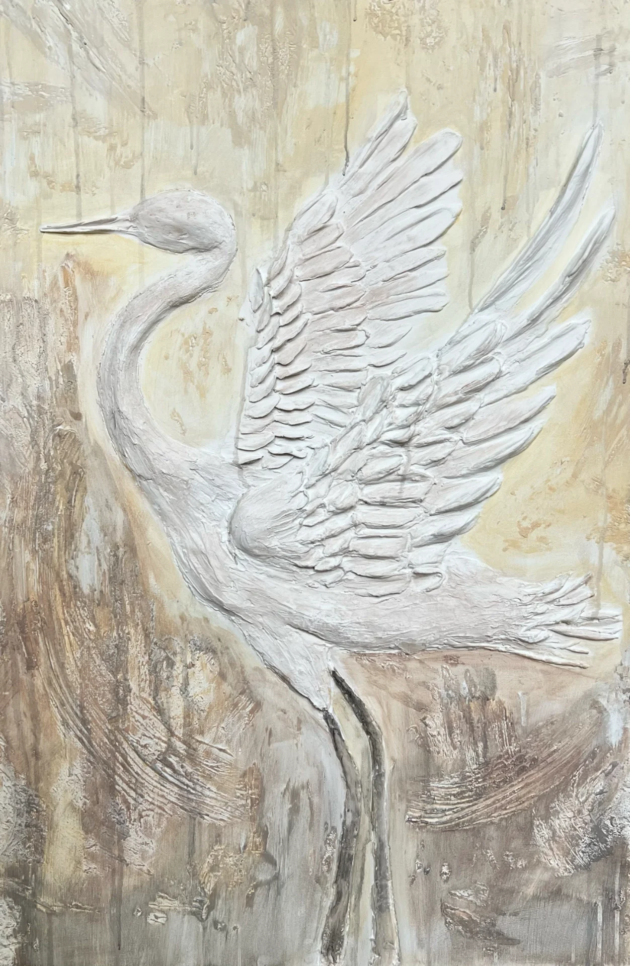 White textured sculpture of a crane with outstretched wings on a neutral background.