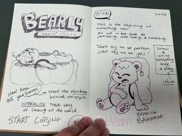 Hand-drawn journal pages with sketches of a bear lying on a pumpkin, and a bear with a sad expression, along with handwritten notes about starting a new journal practice.