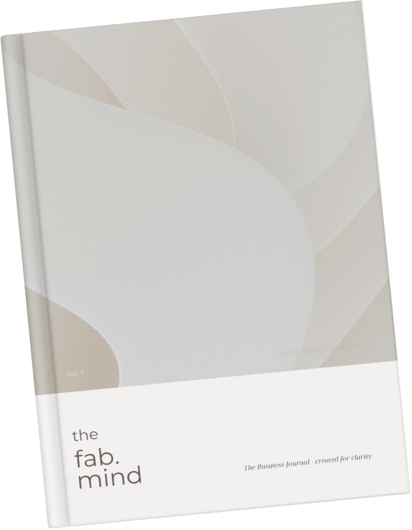 Ein graues Buch mit weißem unteren Abschnitt, der den Titel 'the fab. mind' zeigt, und einem Untertitel 'The Business Journal · created for clarity'.