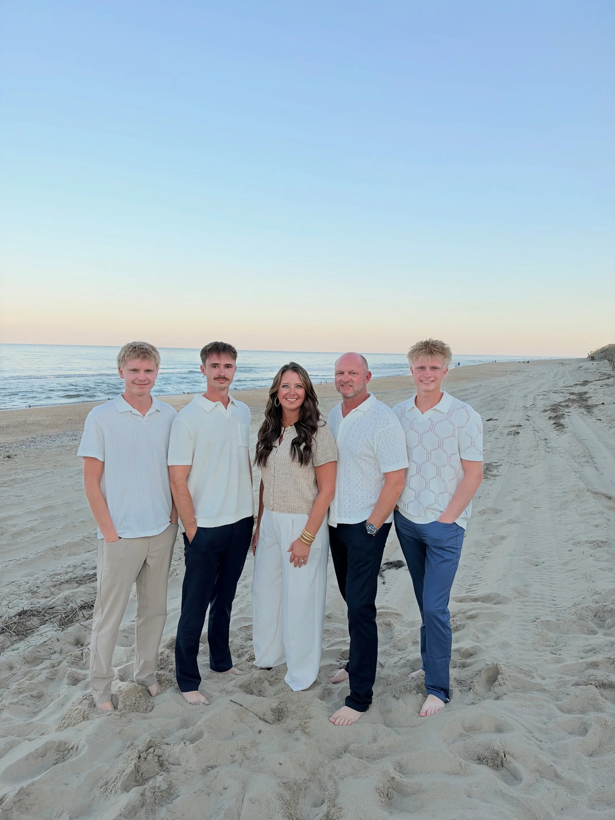 a family dressed in nice clothing on a beach in south carolina