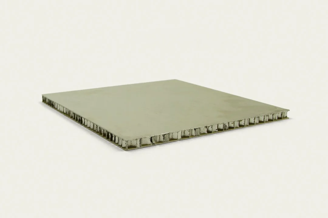 Close-up of a computer processor chip with visible internal structure, placed on a light-colored surface.