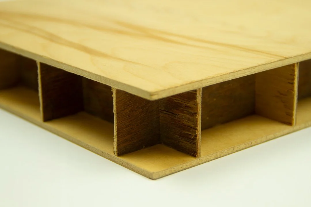 Close-up of a wooden multi-compartment drawer or storage unit with a light-colored top and dark interior sections.