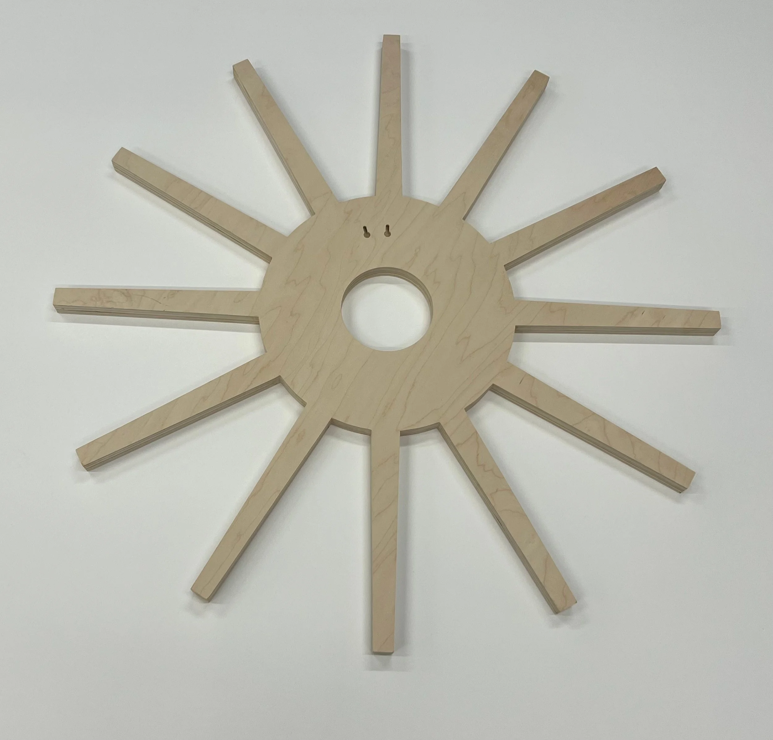 Unfinished wooden star-shaped decor piece with multiple layers of wood, placed on a white surface.