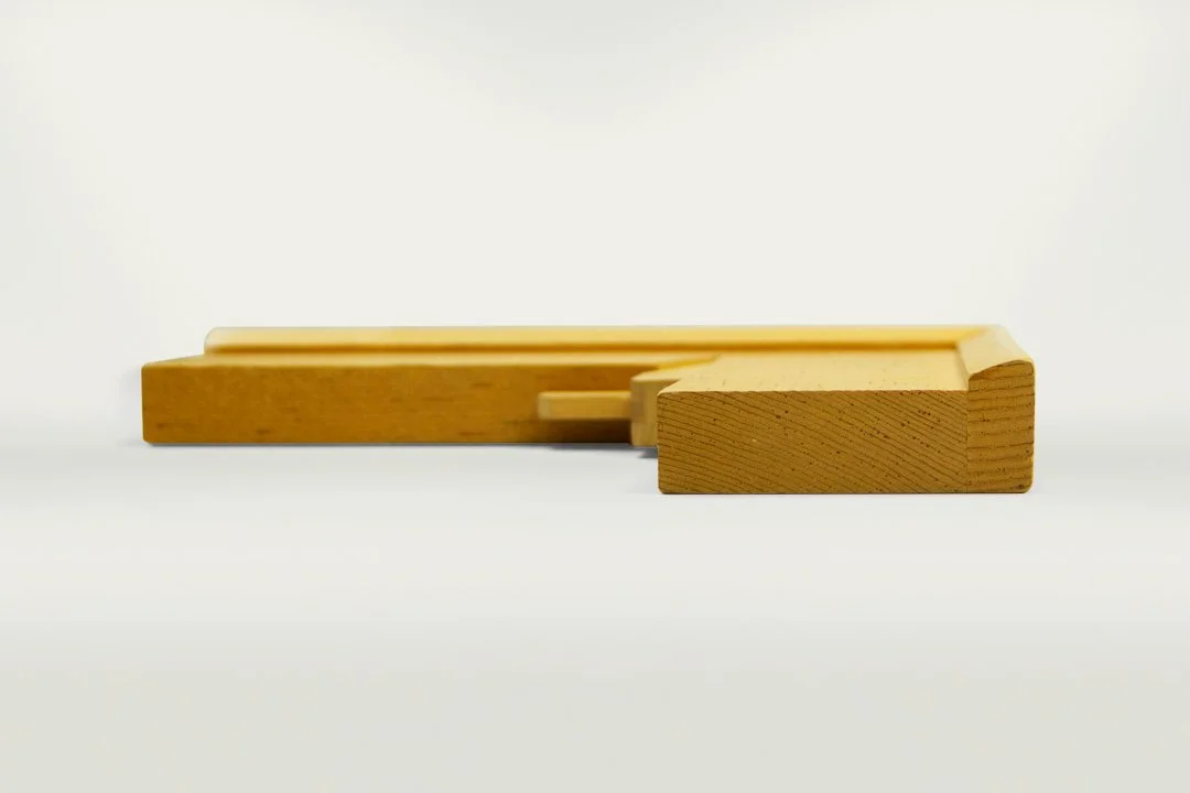 Two wooden chalk holders, one larger and one smaller, with a light wood finish, placed on a white background.