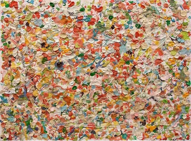 Close-up of a colorful collage made from torn pieces of paper in various colors and textures.