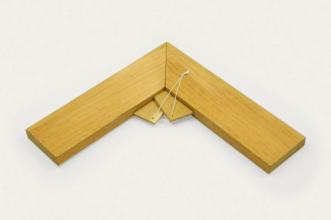 A wooden French stretcher with a tied keys inserted at the corner, used by artists and conservators.