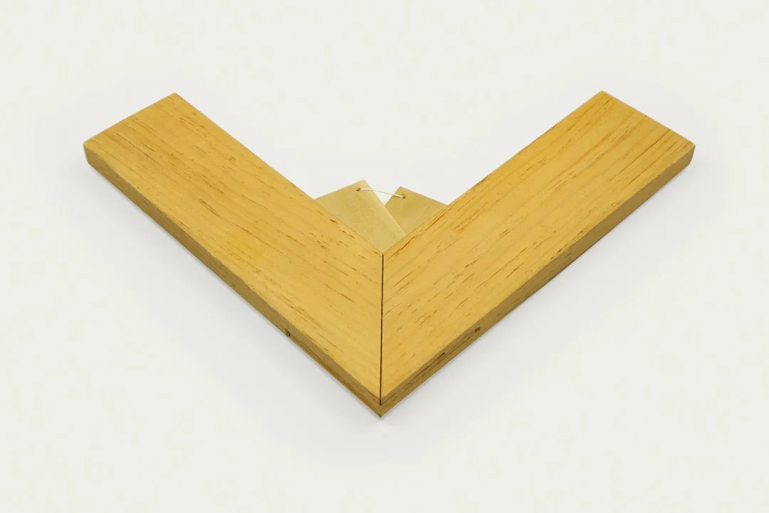 A wooden corner of a French stretcher with a 90-degree angle.