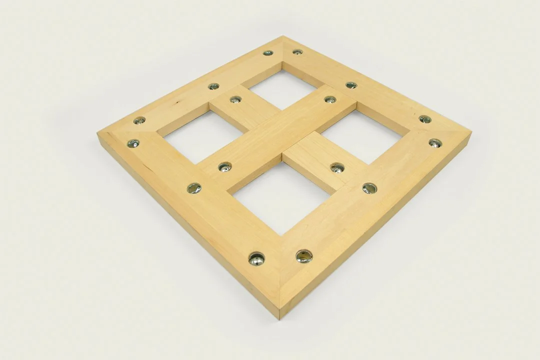 Wooden mechanical stretcher with metal tite-joint fasteners on a white background.