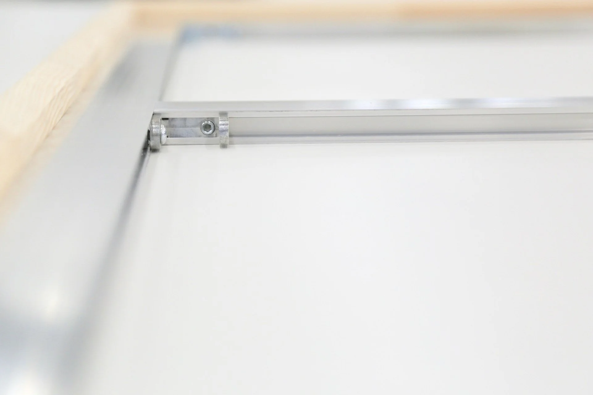 Close-up of a metal sliding door latch on a white door.