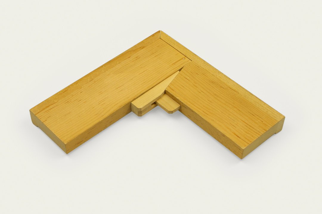 Wooden L-shaped puzzle piece on a white background.