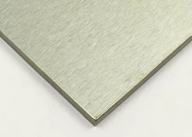 Close-up of a light-colored, textured surface, possibly a wooden or laminate table corner.