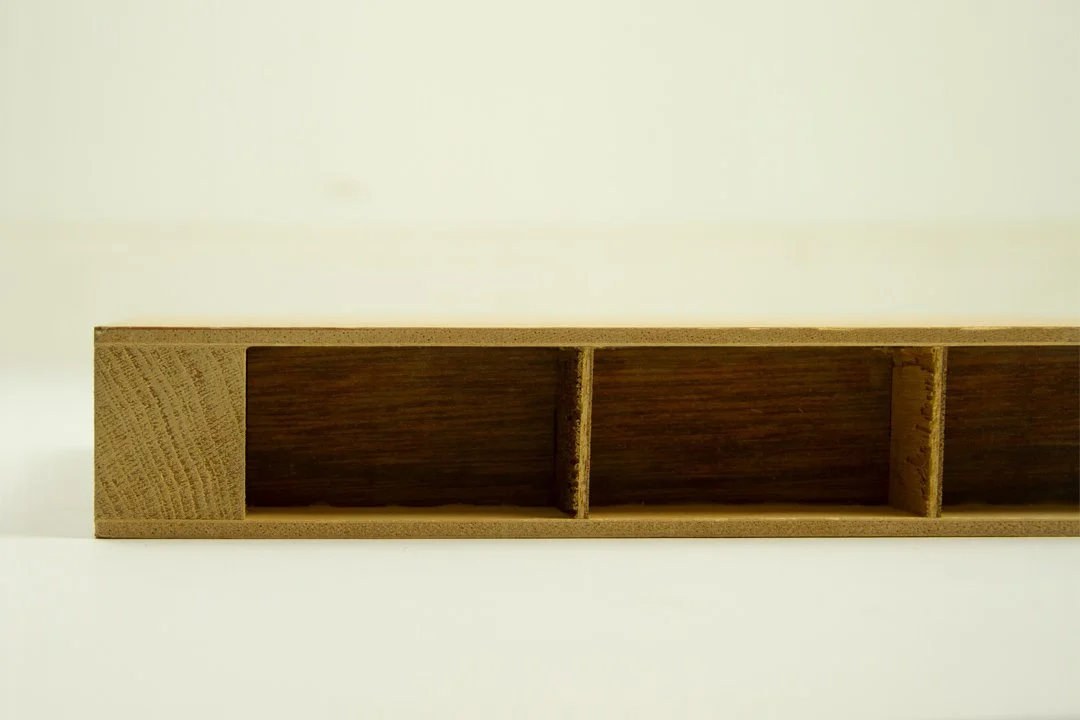 A wooden bookshelf with four compartments, no items inside.