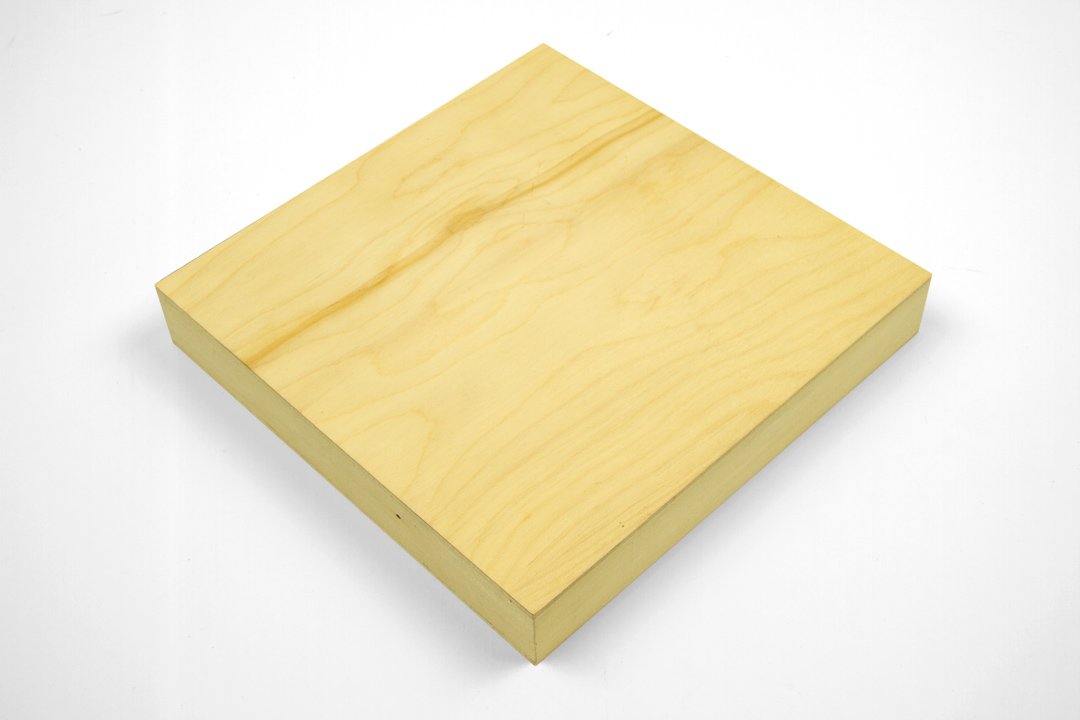 A plain, light-colored wooden block with a smooth surface and sharp edges on a white background.