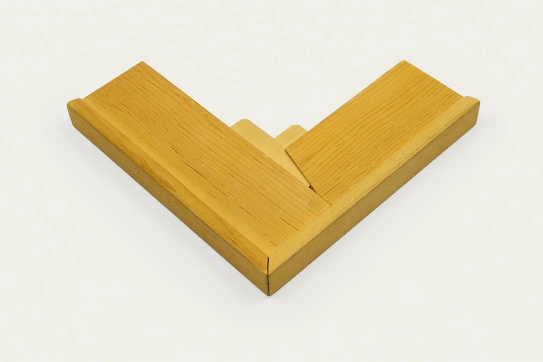 A wooden Italian style stretcher corner on a white background.