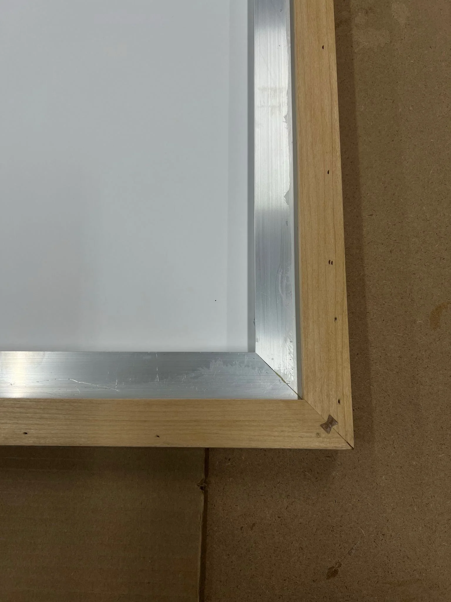 A corner edge construction of a Gatorfoam panel with an aluminum extrusion for extra support at Simon Liu, Inc.