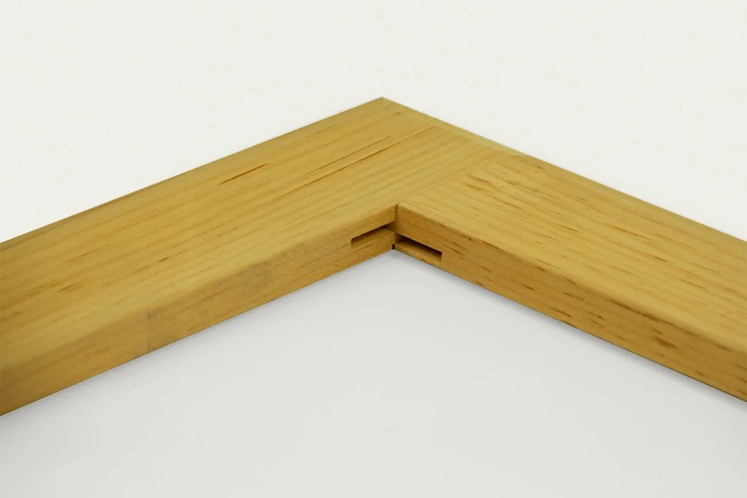 Close-up of a wooden corner joint showing a finger joint connection.