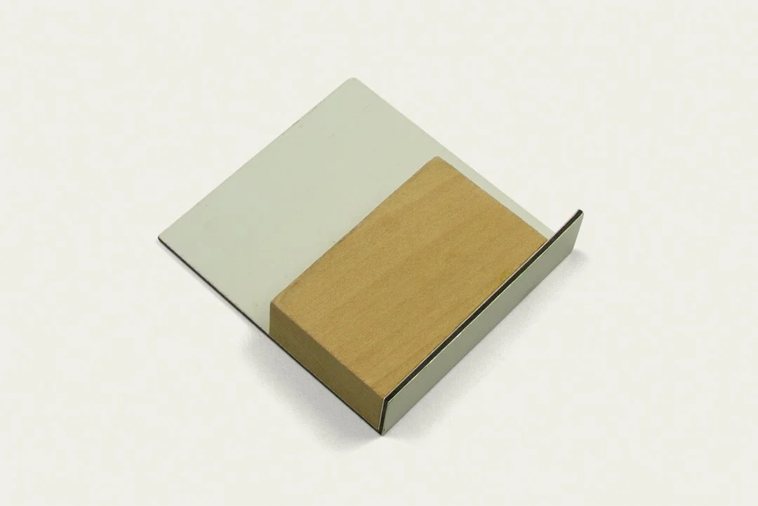 A small gray box containing a wooden stamp and an ink pad.
