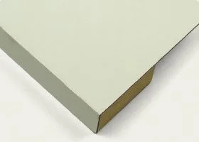 Close-up of the corner of a white painted wooden table with a brown underside.
