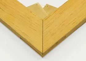 Close-up of the corner of a wooden picture frame with a mitered joint