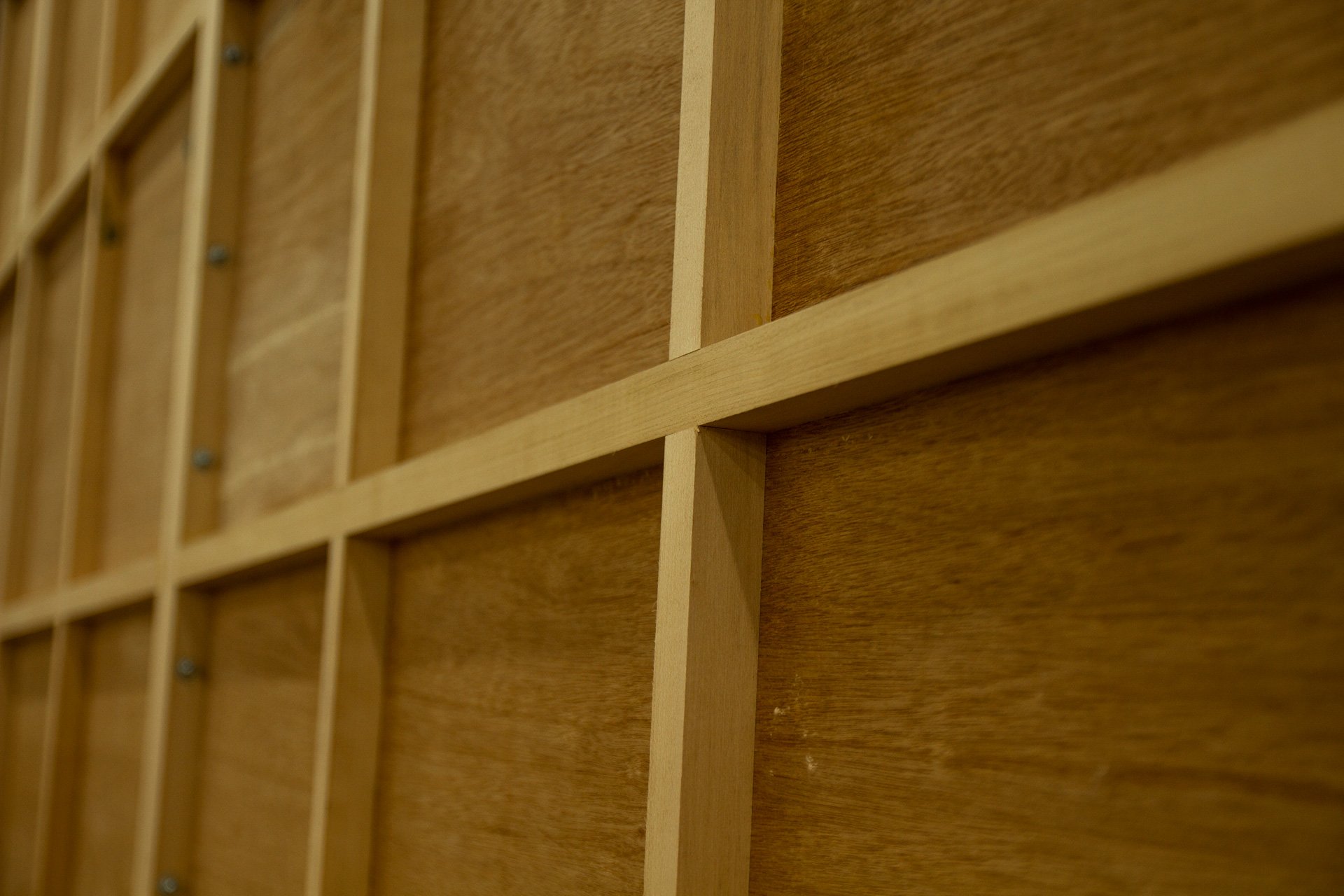 Close-up of a wooden panel (fine art support) with horizontal and vertical crossmembers.