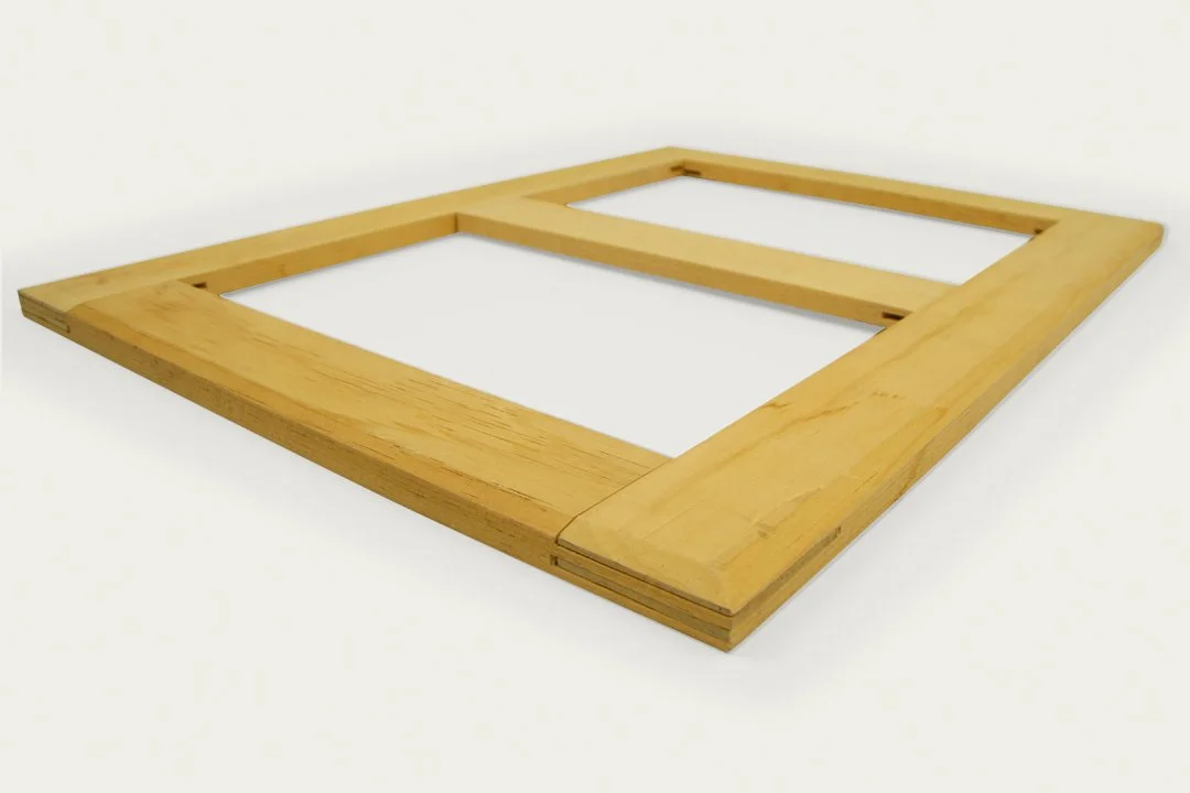 A wooden American Traditional stretcher lying on a white surface.