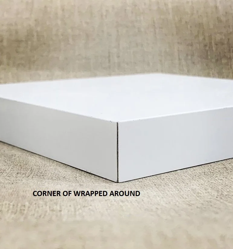 Close-up of a wrap-around edge treatment for a dibond panel profile placed on a textured beige surface.