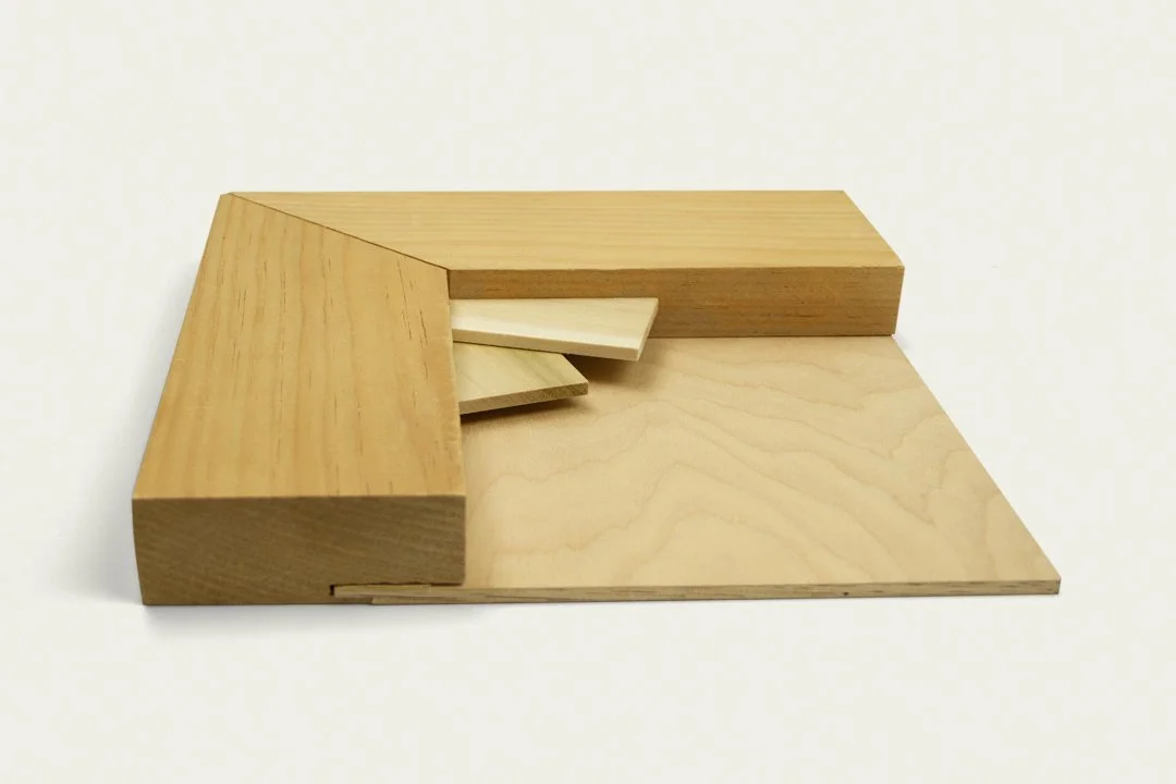 A geometric sculpture made of wooden blocks arranged in an abstract form