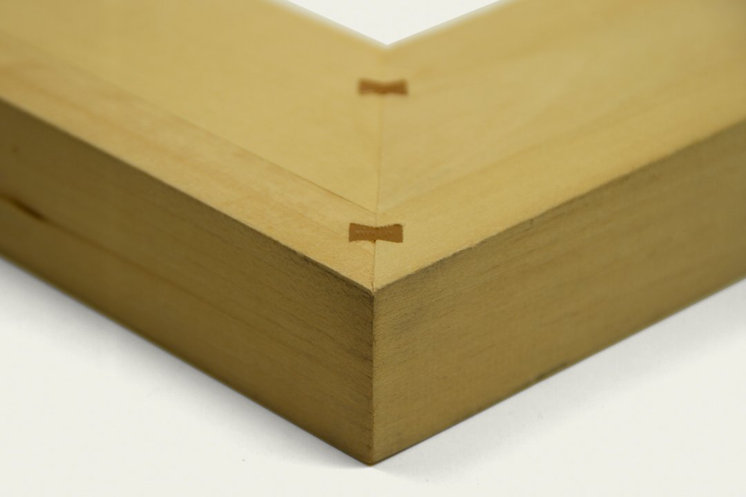 Close-up of a wooden corner joint with interlocking pieces.