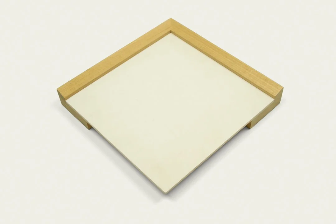 Wooden and white rectangular tray on a white surface.