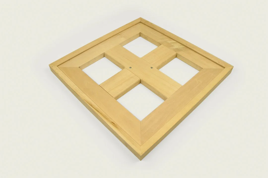 Wooden square frame with four inner squares, designed for support or display purposes.