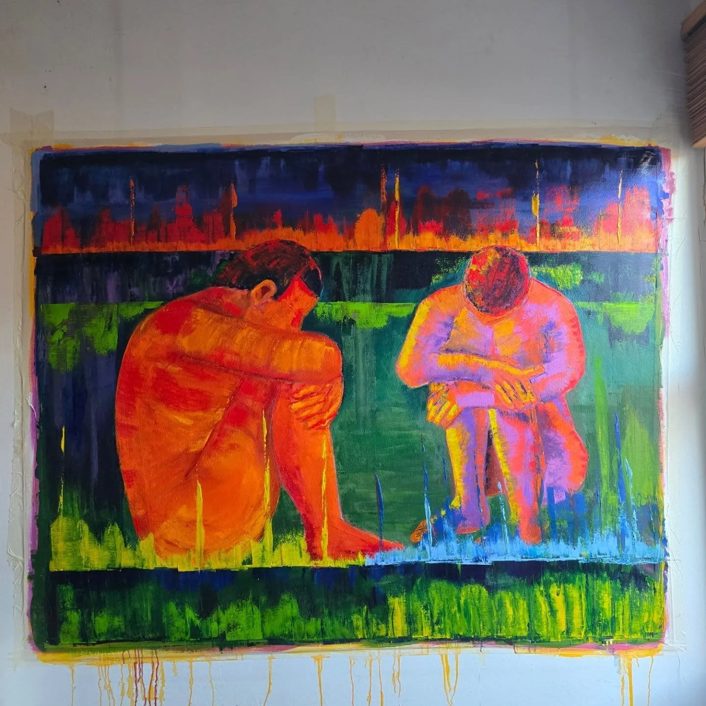 Colorful painting of two people sitting on grass, with a city skyline and sunset in the background.