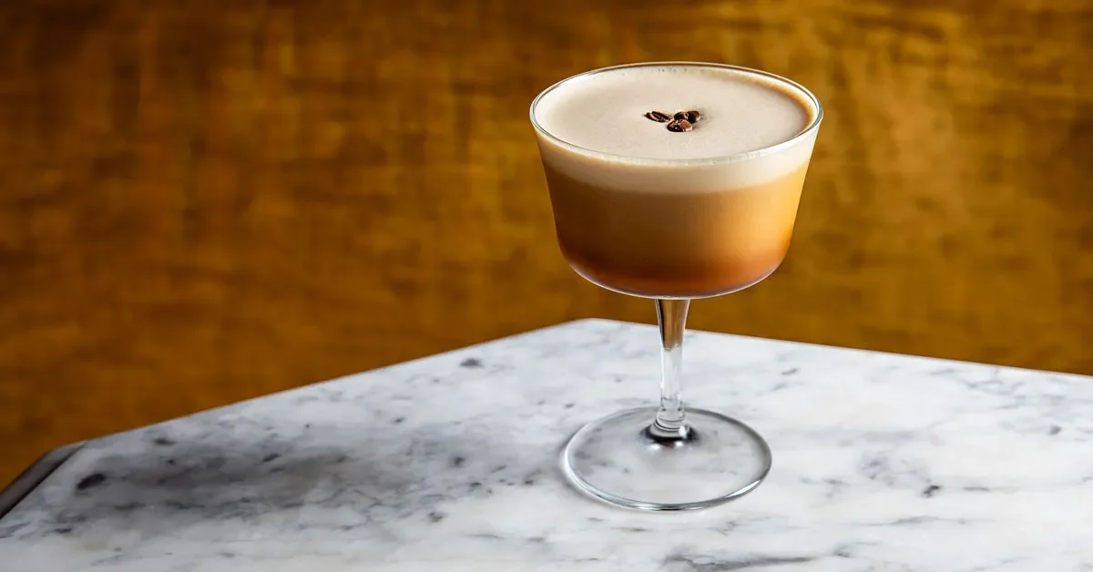 Espresso martini with rich foam and three coffee beans by Sips Up Mobile Bar
