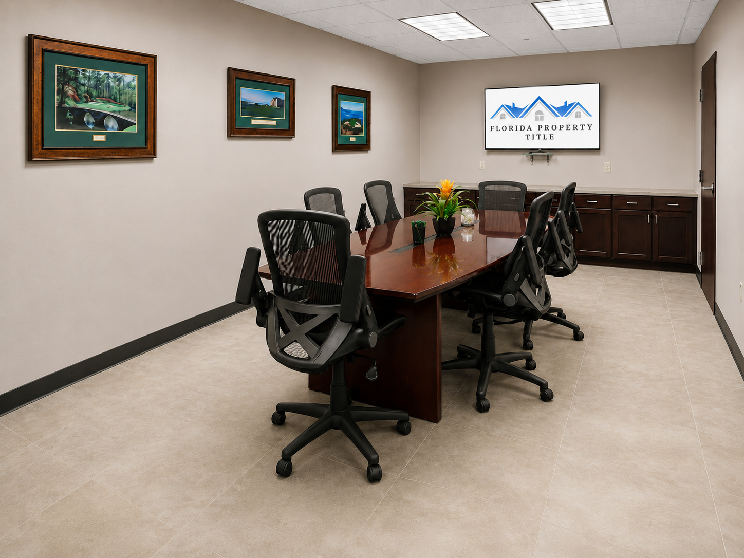 Florida Property Title Estero closing room with polished conference table and client welcome screen in a professional real estate closing setting