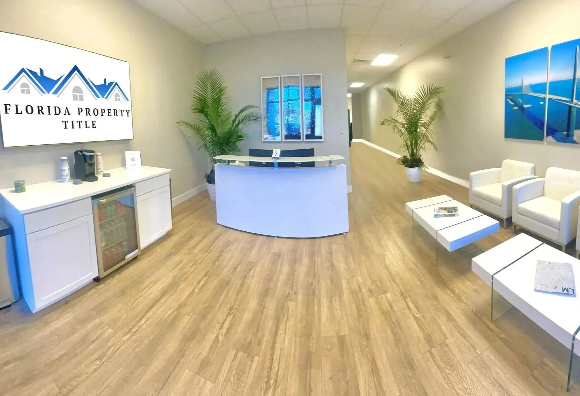 Florida Property Title Cape Coral reception area with beverage center and seating area in a modern professional real estate closing office