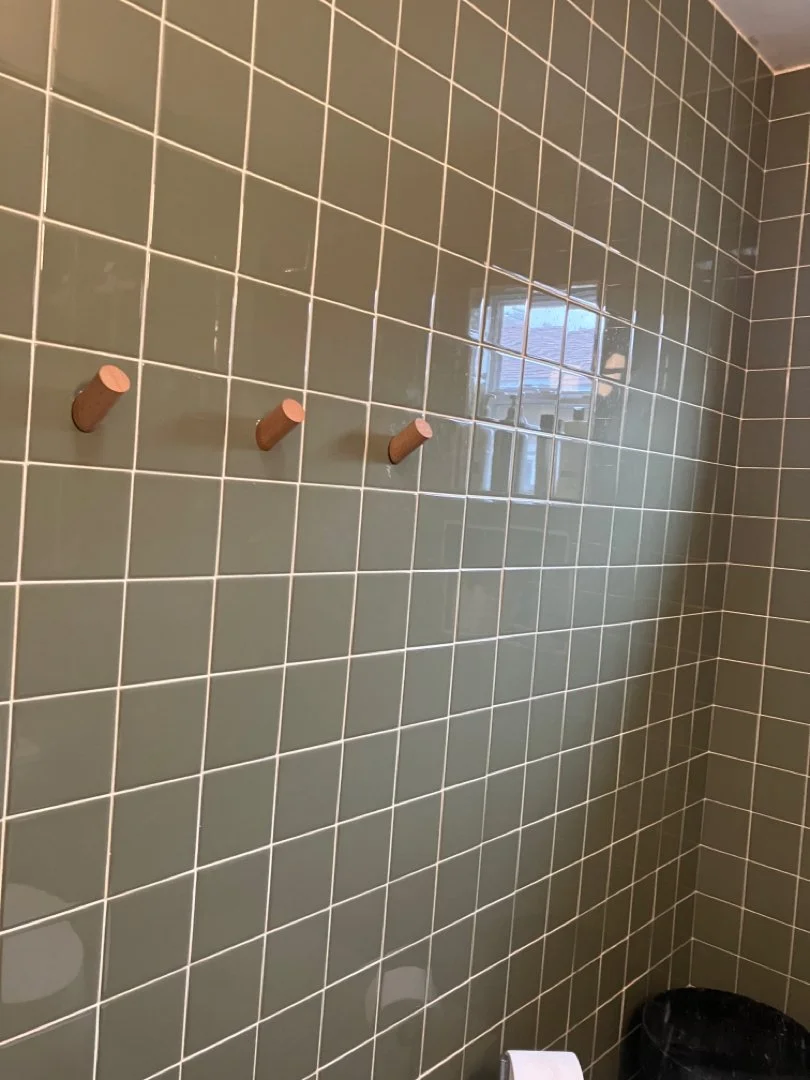Installed hooks on tile wall. 