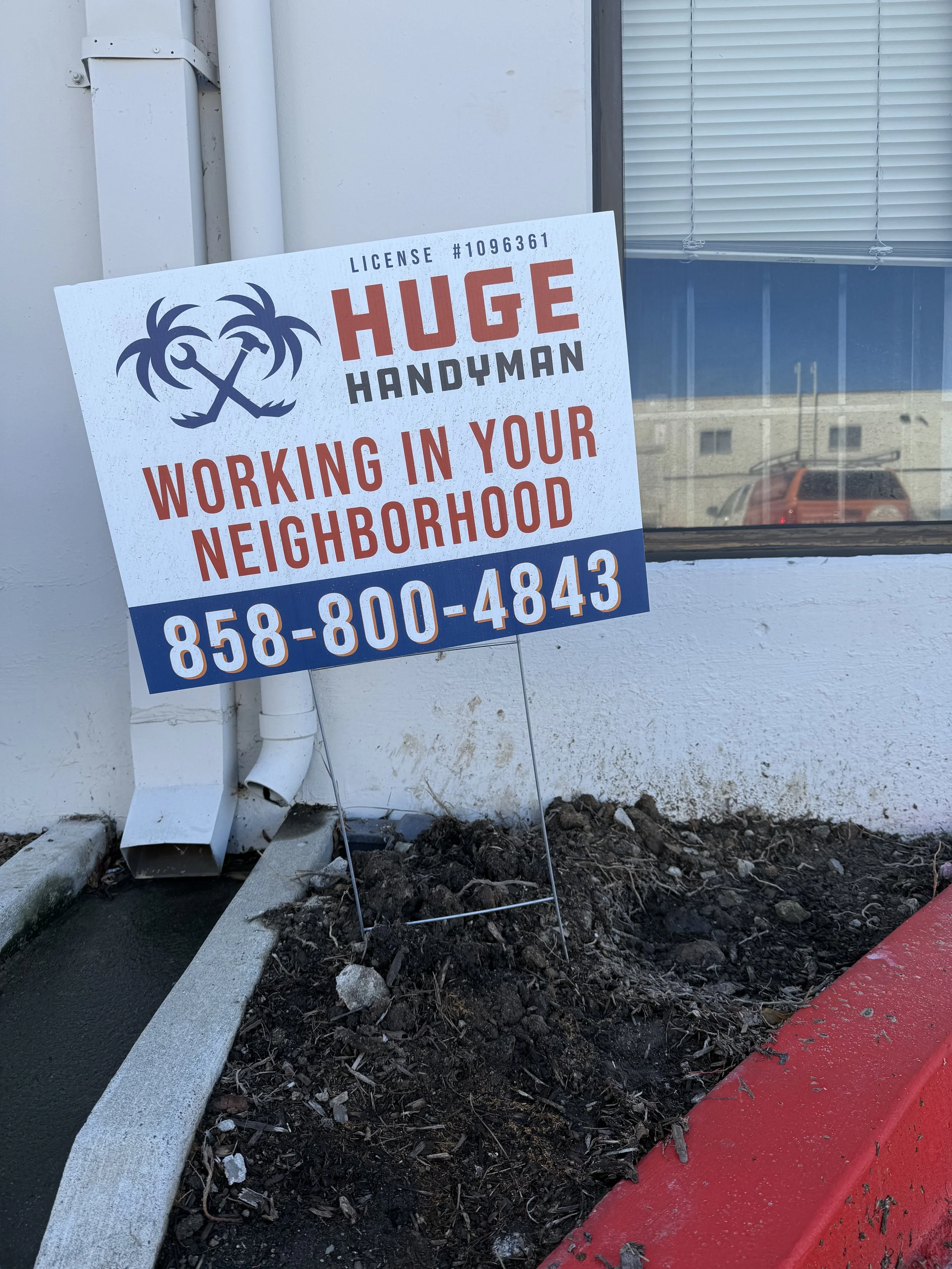 Sign advertising handyman services with a palm tree logo, phone number, and slogan 'Working in Your Neighborhood'.