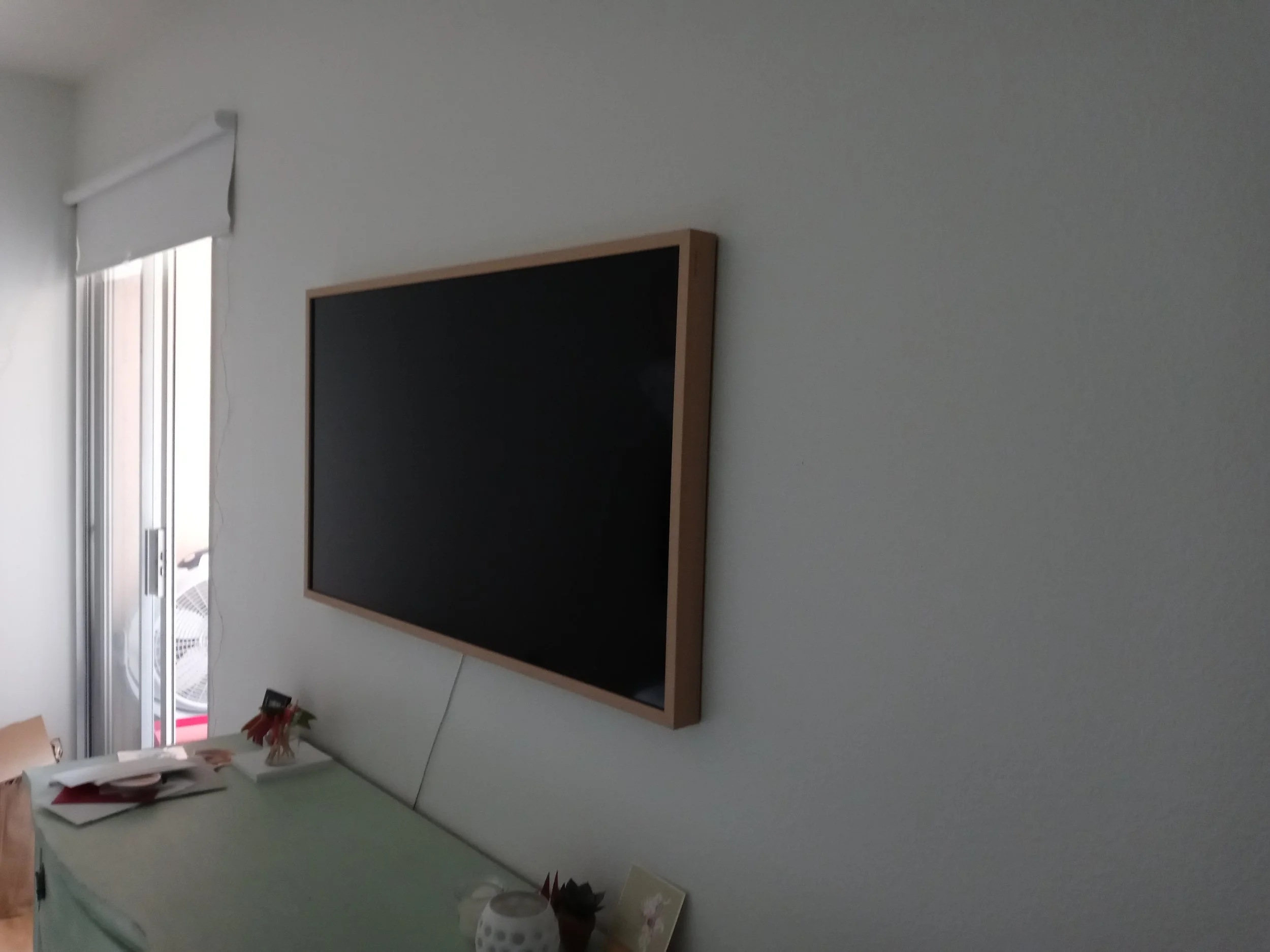 TV with trim professional hung by HUGE Handyman in San Diego home