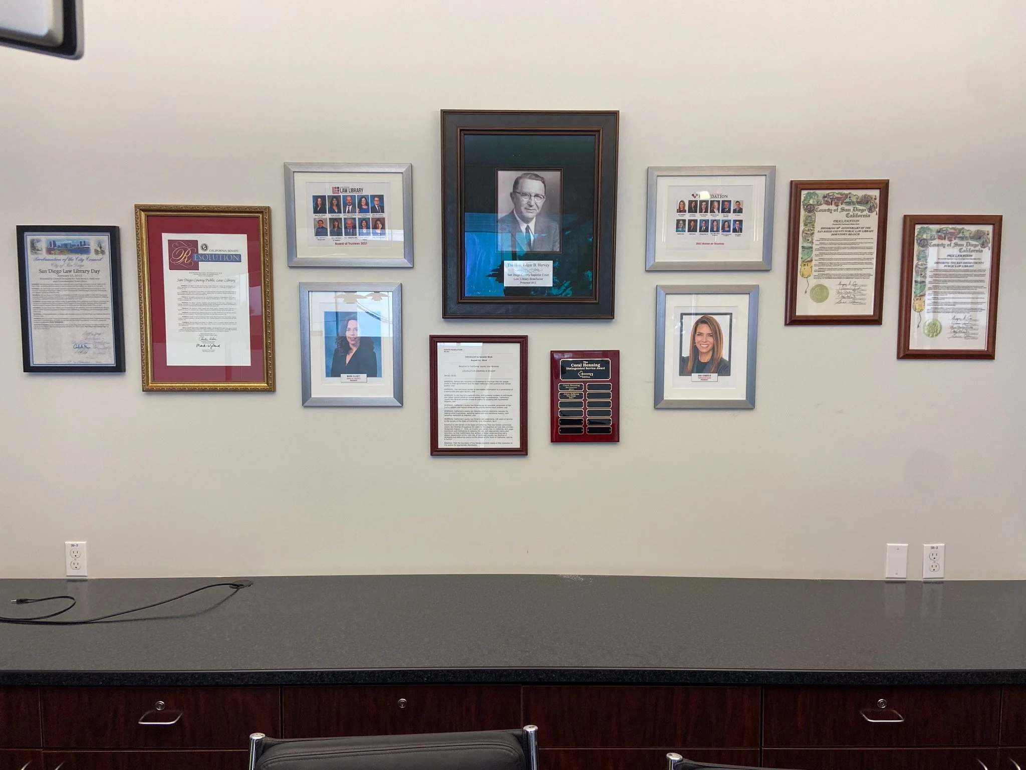 pictures and certificates professionally hung by HUGE Handyman in San Diego office
