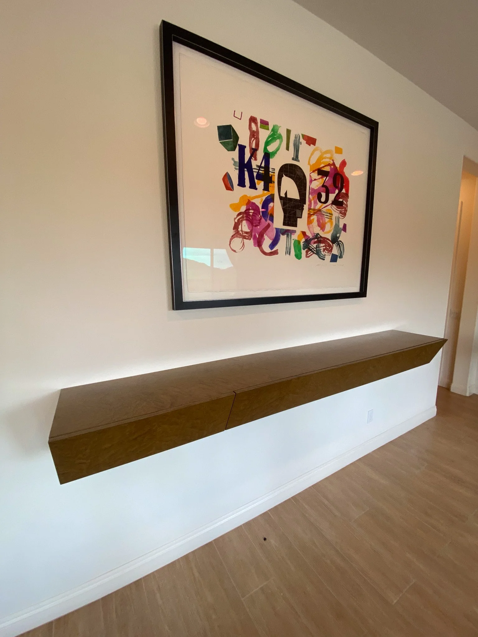 floating shelf and art hung by HUGE Handyman in San Diego home