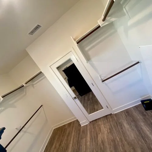 Took existing shelving and moved it up. Then installed hanging rods below.