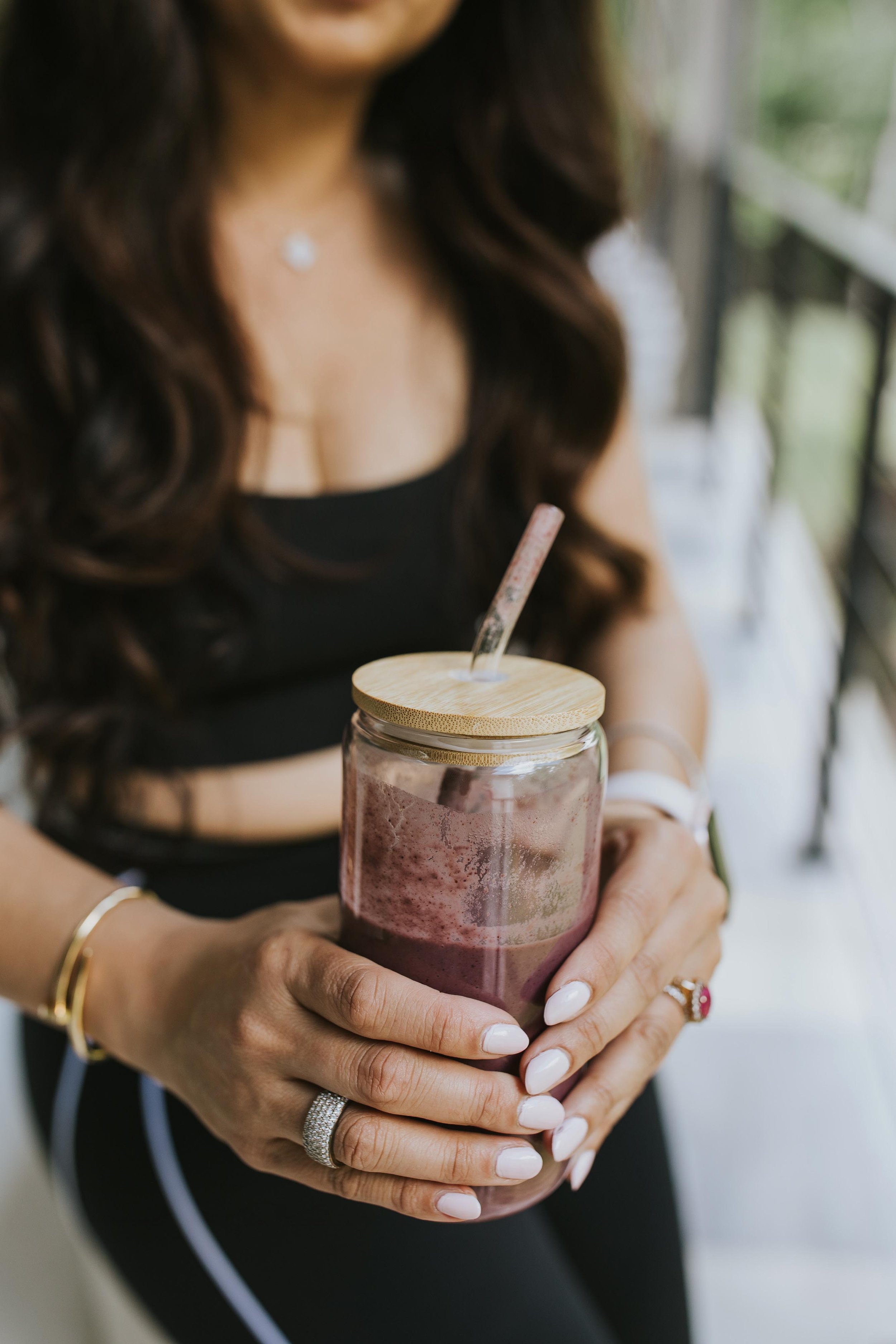 close up of Dr. Sharma holding a purple smoothie