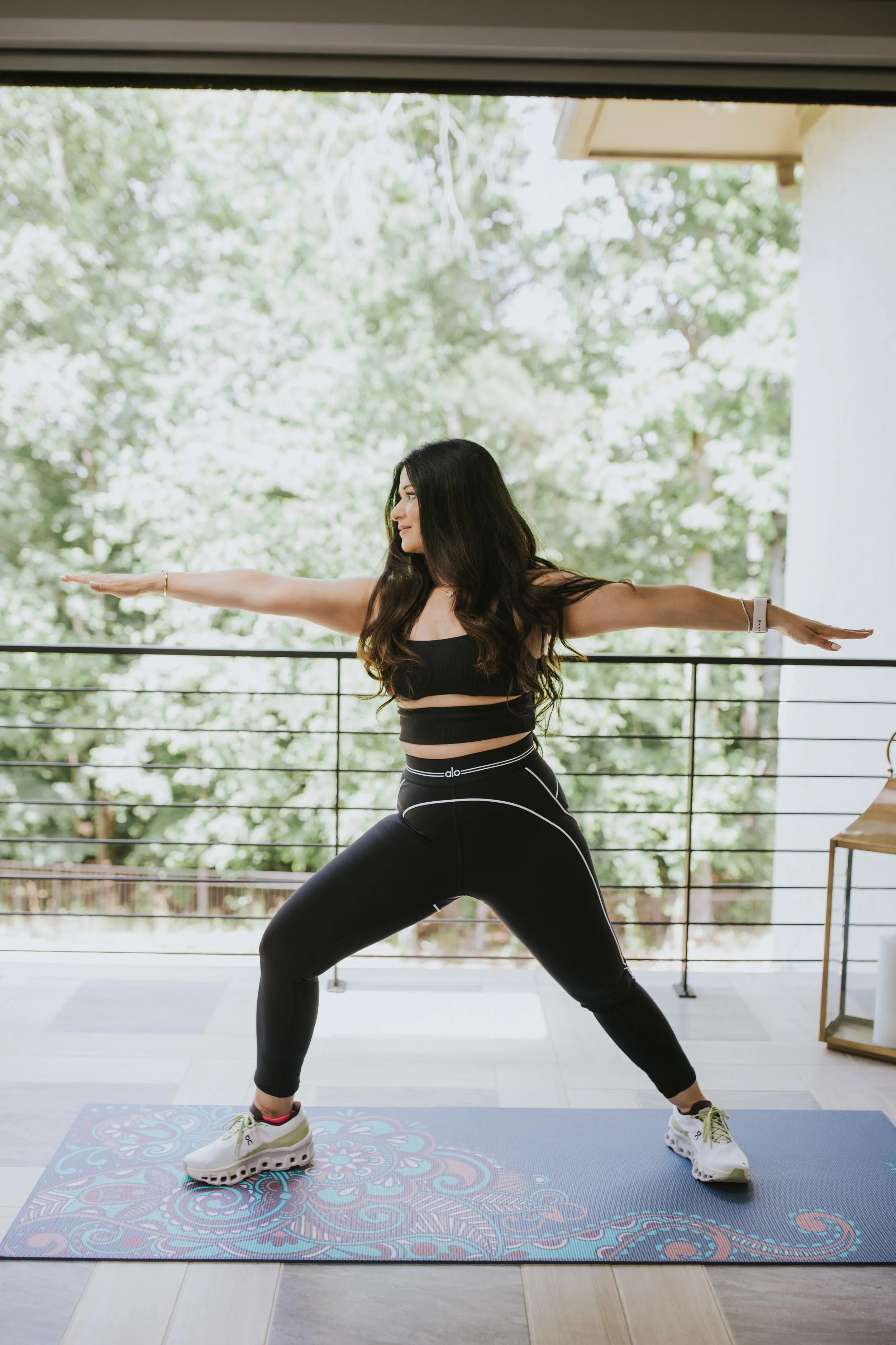 Dr. Sharma doing a yoga pose against a backdrop of trees