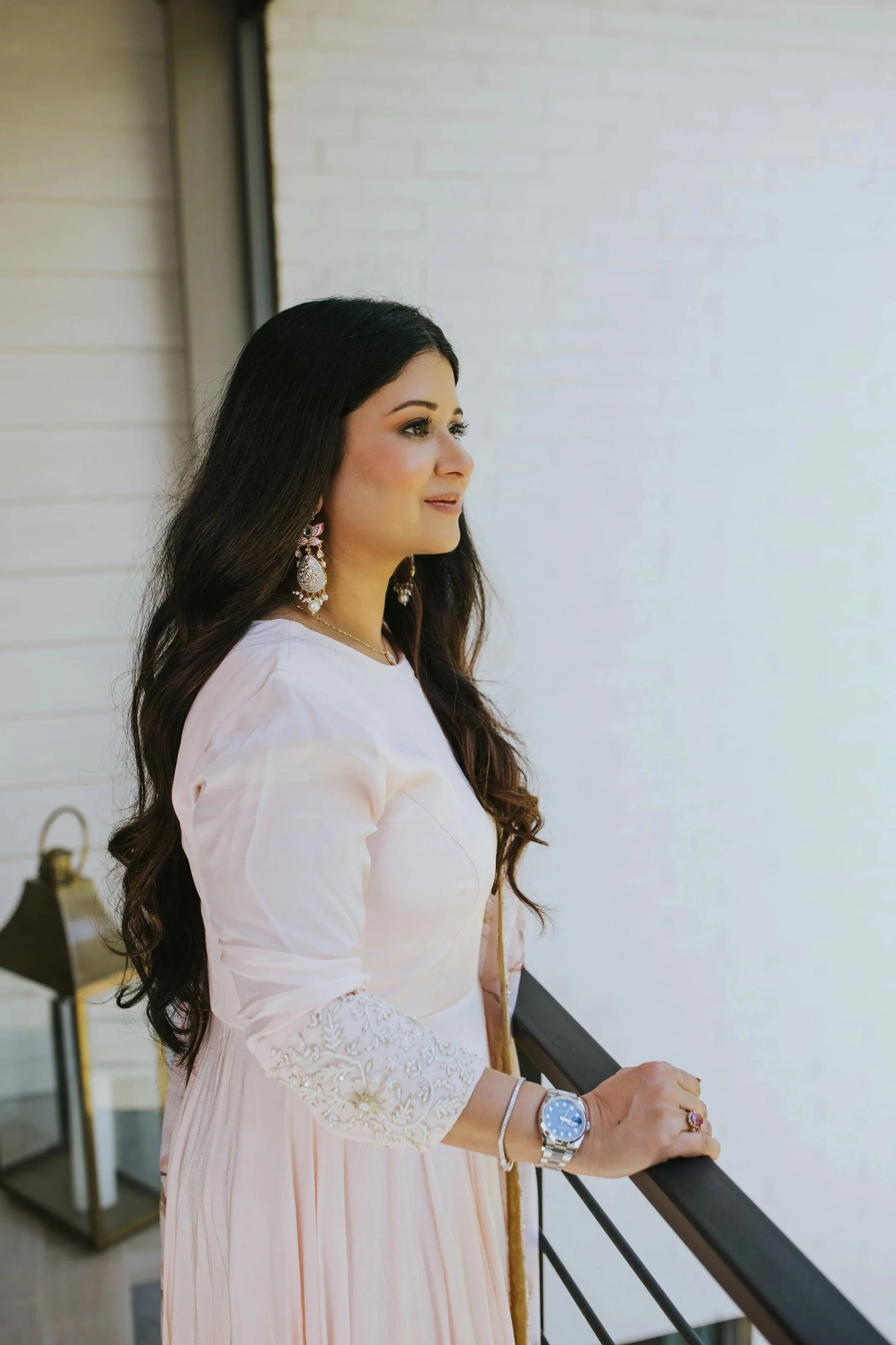 Dr. Sharma looking out over a balcony