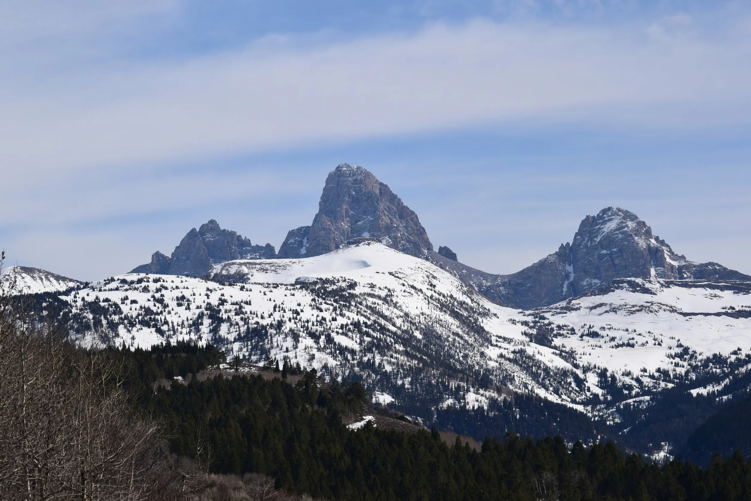 Snow-covered mountain peaks with a clear blue sky.