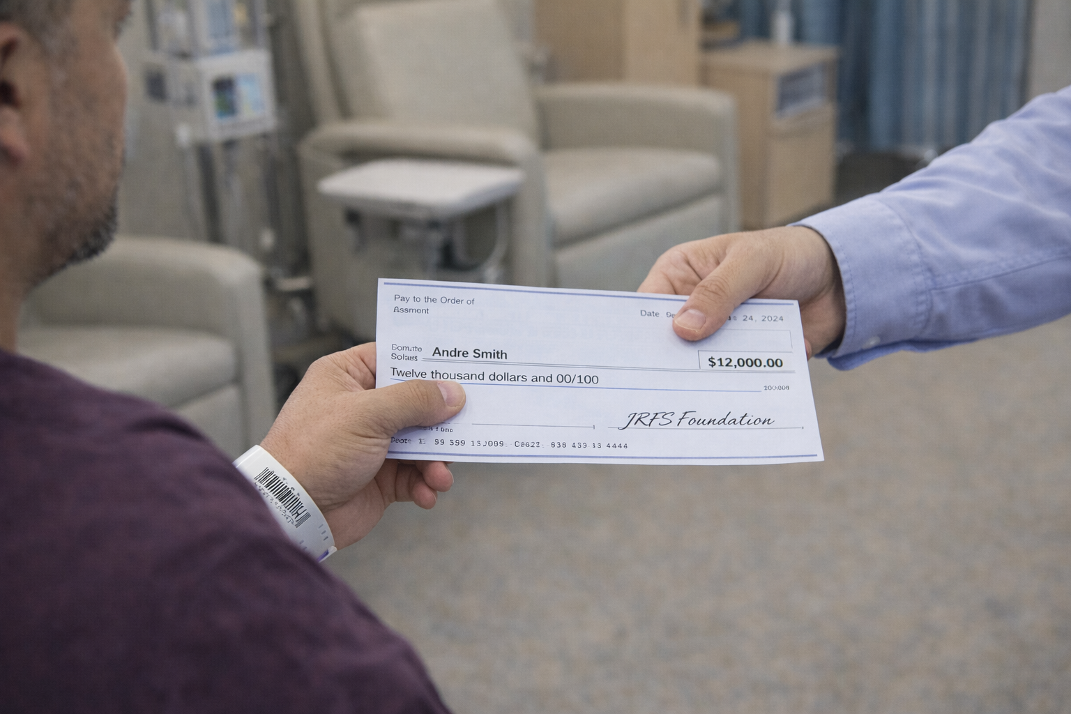 A man handing a check to a patient