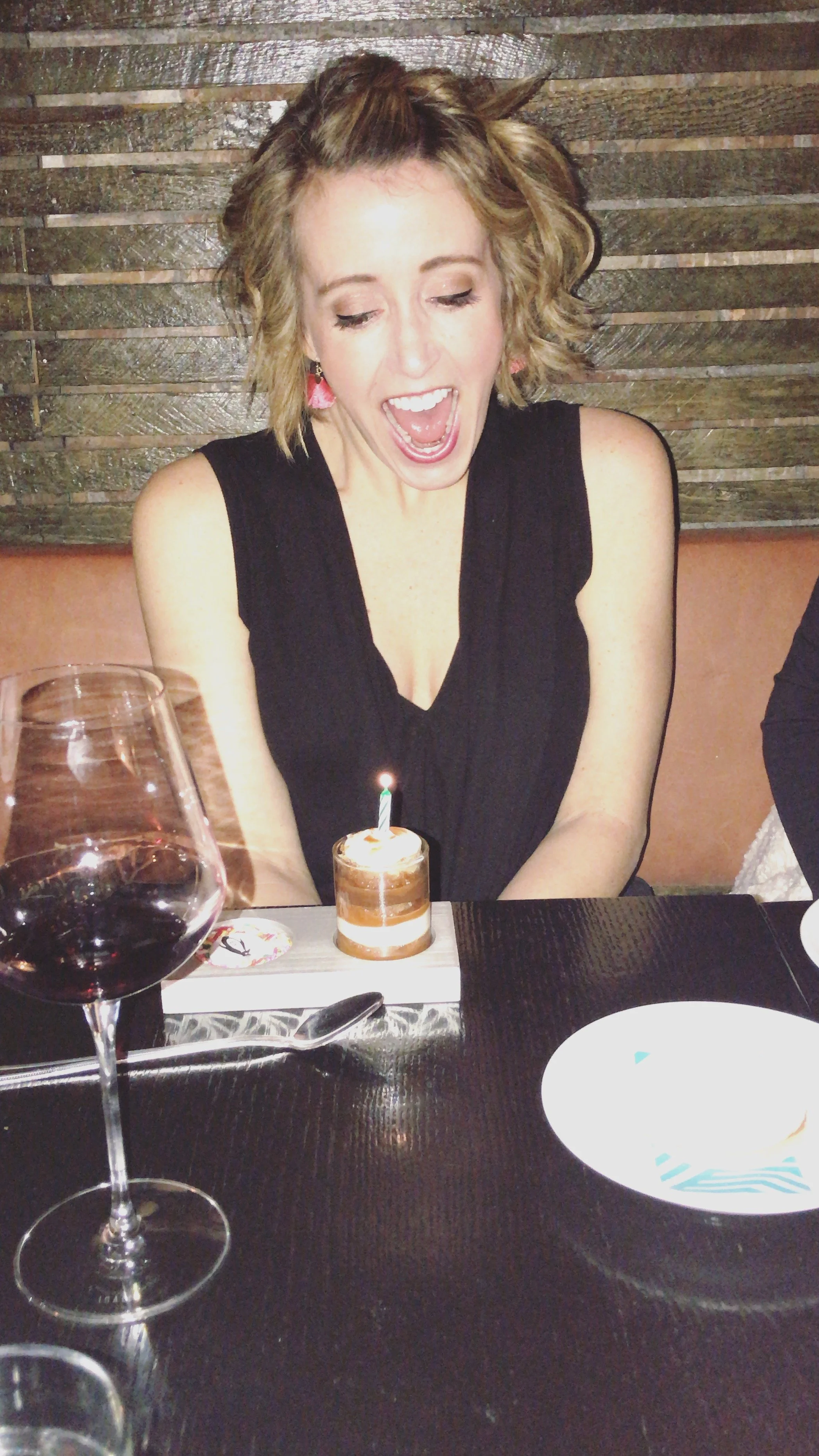 Jayme Rae Forker Schwartz blowing out a birthday candle on a cake